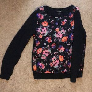 Black sweater with floral print on front